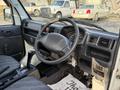Interior view of a 2008 Suzuki Carry showing the steering wheel dashboard gear shift and controls