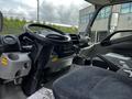 Interior view of a 2018 Hino 195 truck displaying the driver's seat steering wheel gear shifter and dashboard with controls