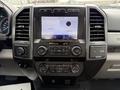 Interior dashboard of a 2022 Ford F600 featuring a touchscreen display with audio controls and climate settings