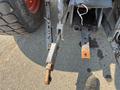 Close-up of a 2010 Kubota M6040 tractor's rear hitch assembly showing metal components and a worn appearance