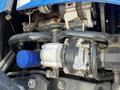 Close-up view of a 2018 New Holland Boomer 45 engine component featuring pipes and a silver motor with a blue cap