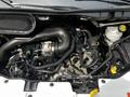 Close-up view of the engine compartment of a 2022 Ford Transit showing various engine components and hoses arranged neatly