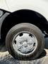 A close-up of a silver wheel with a central hub and black tire on a 2020 Hino 155 truck