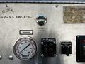 Control panel of a 2006 Emergency One Fire Truck featuring gauges and valves for managing water pressure and pump hours