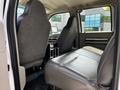 Interior of a 2009 Ford F-550 with two front seats and a central console area showing leather upholstery and a spacious cabin