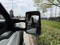 Side mirror of a white 2008 Ford F-550 showing the interior seat and dashboard area visible through the reflection