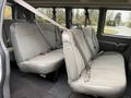 Interior view of a 2021 Chevrolet Express with three rows of gray fabric seats equipped with seatbelts