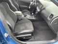 Interior view of a 2022 Dodge Charger featuring black suede and leather seats with a center console and gear shift