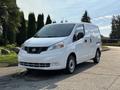 A 2021 Nissan NV200 white commercial van parked on a concrete surface with a clean design and front grille visible