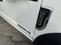 White 2020 Ford F-550 with a chrome emblem featuring the model number F-550 and a badge indicating it has a 6.7L Power Stroke engine