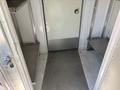 Interior of a 2019 Freightliner MT45 with metal shelves on either side and a diamond plate floor leading to the entrance