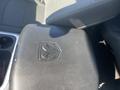 A black leather armrest with the RAM logo on a 2021 RAM 1500 interior