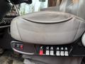 Close-up of the driver's seat of a 2018 Kenworth T800 featuring adjustable controls buttons and a textured leather surface