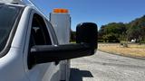 White 2019 RAM 3500 truck with a large side mirror and an amber light on top of the cab