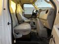 Interior view of a 2017 Ford Econoline showing two front seats and the driver's side dashboard and controls