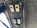 Control panel of a 2010 Kubota F3990 featuring switches and indicators for various functions including lights and wipers