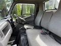 Interior of a 2004 Toyota Toyoace showing two gray upholstered front seats and a dashboard with a gear stick and steering wheel