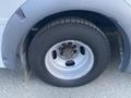 Close-up of a tire and wheel from a 2017 Chevrolet Express with a silver rim and black tire showing the tread pattern