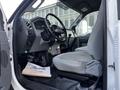 Interior of a 2011 Ford F-750 showing the driver's seat steering wheel and dashboard with controls and a gear shift