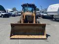 2008 Case Super 580M backhoe loader facing forward with a large front bucket attached