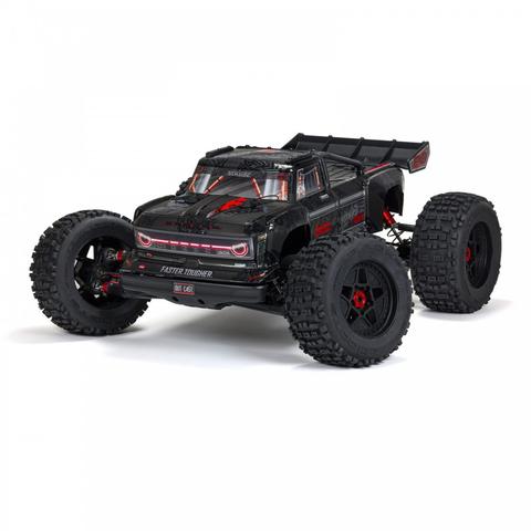 A black Arrma 1/5 Outcast 8S EXB AVC 4X4 RTR Brushless Stunt Truck with oversized tires and a sporty design featuring red accents and aggressive styling