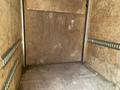 Interior of a 2020 Stealth Enterprises Trailer featuring wooden walls and a flat floor with metal tie-down rails along the sides
