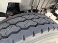 Close-up of a heavy-duty tire showcasing a rugged tread pattern designed for durability on various terrains