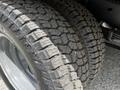 Close-up of a large, rugged tire with a deep tread pattern designed for off-road usage on a 2018 Ford Econoline