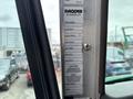 Interior view of a 2013 Kenworth T370 truck dashboard displaying a Paccar information label with truck model details and caution notice