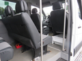 A 2009 Dodge Sprinter Van showing the interior with black leather seats and a driver's area visible in the foreground