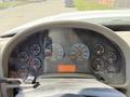 Dashboard of a 2009 International 7500 showing various gauges including speedometer, RPM, fuel level, and engine temperature with illuminated warning lights