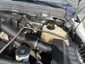 Engine compartment of a 2014 Ford F-350 SD showcasing the air intake, coolant reservoir and various engine components