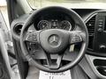Steering wheel of a 2023 Mercedes-Benz Metris featuring controls and the Mercedes-Benz logo in the center