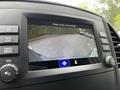 A rearview camera display showing a parking area with vehicles and guidance lines on a 2023 Mercedes-Benz Metris
