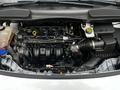 Engine compartment of a 2014 Ford Transit Connect showcasing the engine assembly and various components