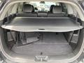 The image shows the cargo area of a 2015 Kia Sorento with a retractable cover and folded floor mats in the back
