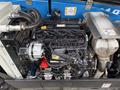 Engine of a 2020 Genie GTH-5519 with various components including hoses and an alternator visible on the left side