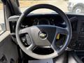 Steering wheel of a 2019 Chevrolet Express featuring the Chevy emblem and control buttons on the left side