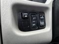 Control panel with buttons for mirror adjustments, light settings, and panel illumination in a 2017 International WorkStar 7600