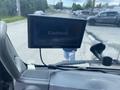 A Garmin GPS device mounted on the dashboard of a 2012 Hino XJC720 truck displaying the Garmin logo