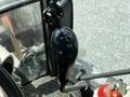 A close-up view of the gear shift lever inside a 2011 Kubota M8540D tractor showing various gear positions on the top of the lever