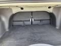 The interior trunk space of a 2005 Chrysler PT Cruiser showing a black carpeted floor and two gray felt-covered compartments on the back wall