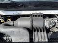 Engine compartment of a 2019 Ford Econoline featuring an air intake and various components including hoses and tubing