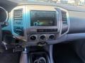 Interior dashboard of a 2010 Toyota Tacoma featuring the central radio display and control knobs