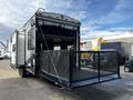 A 2022 Heartland Torque toy hauler with a ramp door open revealing a spacious loading area enclosed by a black mesh railing