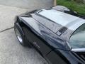 A 1972 Chevrolet Corvette with a sleek black body and silver detailing on the hood showcasing its classic design and sporty features