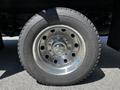A close-up of a chrome wheel rim with a thick black tire featuring the Firestone Transforce label