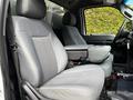 Front seats of a 2016 Ford F-550 with gray upholstery and a center console