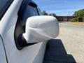 A white 2011 Chevrolet Colorado side mirror reflecting light with a smooth design