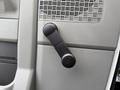 The image shows the manual window crank handle of a 2022 Ford E-450 in a gray interior setting